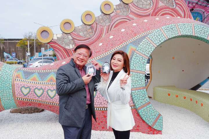 藝人王彩樺與雲管處徐振能處長手持「全新吉祥物」吊飾合影